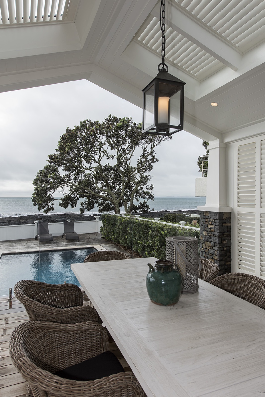 Loggia outdoor dining with pool and sea view